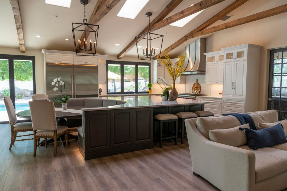 Luxurious open concept kitchen featuring sleek cabinetry, large island, and stylish lighting.