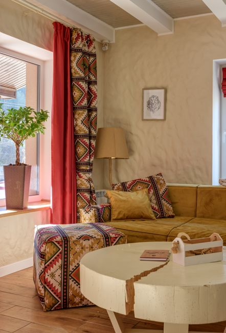 Home Warm and inviting living room with ethnic decor and bright natural light.